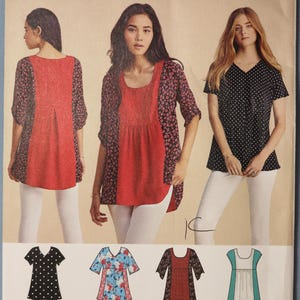 May include: Simplicity sewing pattern 8052 for a top with a scoop neckline and short sleeves. The pattern includes four variations featuring different fabric patterns, including polka dots, floral prints, and solid color panels with a back pleat.