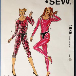 May include: A Kwik Sew sewing pattern envelope, number 1935, for sizes XS-S-M-L. The front features illustrations of two long-sleeved leotards with black waist accents, one in a pink animal print and one in solid pink, designed by Kerstin Martensson.