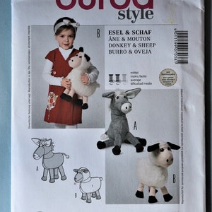 May include: A Burda Style 7038 sewing pattern envelope for a donkey and sheep plush toy. The front features a child holding a sheep, photos of the finished grey donkey and white sheep, line drawings of both animals, and text in multiple languages.
