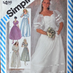 May include: A Simplicity 6241 sewing pattern envelope featuring illustrations of various wedding dresses with puff sleeves, sweetheart necklines, and full skirts. The cover displays a white gown with ribbon accents and a veil, size 10, Eur 38.