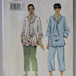 May include: A Very Easy Vogue sewing pattern, R10105, featuring two women's outfits. One outfit is a white top with a floral pattern and green pants. The other is a light blue top and pants.