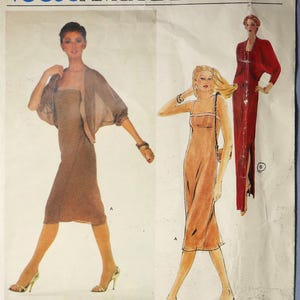 May include: Vintage Vogue American Designer sewing pattern featuring three dress designs. The illustration shows a woman in a brown dress with a matching sheer jacket, another in a peach-colored dress, and a third in a red dress. The pattern is by Jerry Silverman.