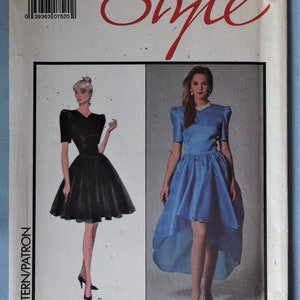 May include: Carolina Herrera sewing pattern featuring two dress designs. The pattern includes a size 10, with the word "Style" in a red script. One dress is black, the other is blue with a high-low hemline.