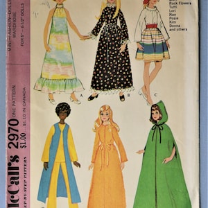 May include: McCall's 2970 sewing pattern for 5 to 6.5 inch dolls. The envelope features illustrations of six outfits: a tie-dye maxi dress, a black floral gown, a striped skirt set, a yellow and blue pantsuit, an orange robe, and a green hooded cape.