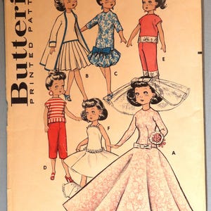 May include: A Butterick printed pattern envelope for a 20 inch doll, numbered 8798. The cover features illustrations of six doll outfits labeled A through F, including a wedding gown with a veil, a striped top with pants, and various dresses.