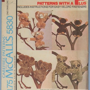 May include: A McCall's 5830 sewing pattern envelope titled Patterns With A Plus. The front features illustrations of various brown and tan stuffed animals resembling koalas and monkeys perched on tree branches, with instructions for Velcro fasteners.