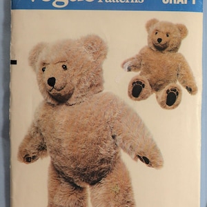 May include: A Vogue Patterns 569 Craft sewing pattern envelope featuring a tan plush teddy bear. The front shows a standing bear and a seated bear with dark paw pads. The text reads Vogue Patterns 569 CRAFT and Designed by LINDA CARR.