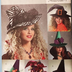 May include: A Butterick B4888 sewing pattern envelope featuring six variations of witch hats. The designs include a zebra print hat, a black hat with an orange buckle, a green hat with a purple bat, a purple hat with orange pumpkins, a pink hat with roses, and a black hat with red accents.