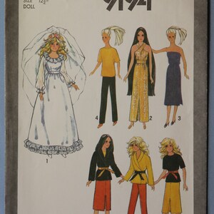May include: Simplicity pattern 9194 for a 12 1/2 inch doll. The envelope features illustrations of a doll wearing a white wedding dress with a veil, plus various outfits including a yellow top with pants, a gold gown, a purple dress, and jackets with skirts or pants.