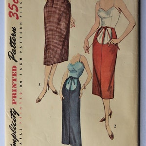 May include: Vintage Simplicity printed pattern featuring three skirt designs. The pattern includes a pencil skirt, a high-waisted skirt, and a skirt with a unique apron-like detail. The pattern is marked with the number 4004 and the price 35c.