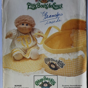 May include: A Butterick sewing pattern envelope 6661 for Cabbage Patch Kids featuring a doll in a yellow and white gingham outfit and a matching doll carrier. The envelope includes the text Cabbage Patch Kids, P'tits Bouts de Choux, and No transfers inside.