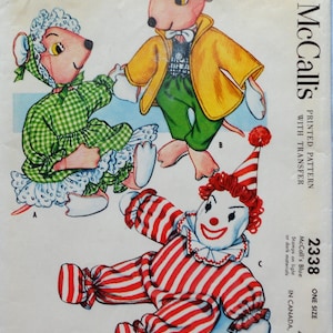 May include: A McCall's sewing pattern envelope for stuffed sock toys, featuring illustrations of a clown and two mice. The clown wears a red and white striped suit, while the mice are dressed in green gingham and a yellow jacket with green pants.