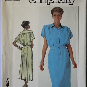 May include: Simplicity sewing pattern 7942, size K, featuring a two-piece outfit with a short-sleeved button-down shirt and a matching skirt. The pattern envelope displays a blue ensemble and a yellow line drawing illustration of the garment.