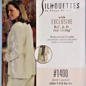May include: A sewing pattern package for Joan's jacket, sizes 1-4 and 5w-8w. The package features a woman wearing a beige jacket and pants. The text on the package reads "SILHOUETTES by Peggy Sagers" and "EXCLUSIVE B,C, & D cup sizing".