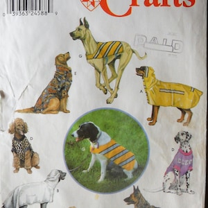May include: Simplicity Crafts pattern featuring various dog clothing designs. The cover shows illustrations of dogs wearing raincoats, sweaters, and vests. The pattern includes sizes for one size. The Longia Miller Design logo is visible.