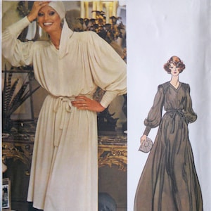 May include: Vogue Couturier Design sewing pattern featuring a cream-colored dress with long, voluminous sleeves and a tie waist. The pattern includes a drawing of a similar brown dress. The text "JEAN MUIR" is visible.