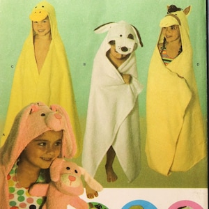 May include: Simplicity pattern for hooded towels and mitts. The image shows children wearing animal-themed hooded towels: a duck, a dog, a horse, and a bunny. The mitts feature matching animal designs. The pattern number is 4817.