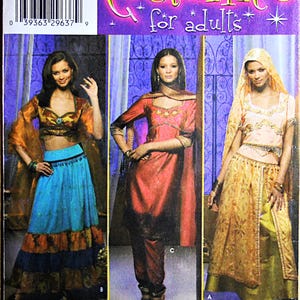 May include: A Simplicity 4249 sewing pattern envelope for adult costumes featuring three distinct outfits. The designs include a blue tiered skirt with a cropped top, a red tunic with matching pants, and a gold-toned dress with a head covering.