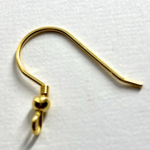 May include: Gold earring hook with a small ball at the end. The hook is made of metal and is designed to be attached to an earring.