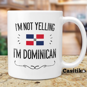 May include: White ceramic mug with a black and white design that says "I'm not yelling I'm Dominican" with the Dominican Republic flag in the middle. The mug has a black handle and the word "Casitika" is printed on the bottom.