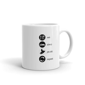 May include: White ceramic coffee mug with black text and icons that reads "eat, sleep, jet ski, repeat".
