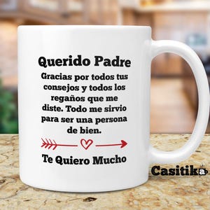 May include: White ceramic mug with a black and red design. The mug reads "Querido Padre" and includes a message of appreciation for a father's guidance and support. The text also includes "Te Quiero Mucho" and a small heart.
