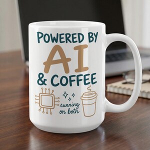 May include: A white ceramic mug featuring the text "POWERED BY AI & COFFEE" in dark blue and tan. Below the text, there is a tan computer chip icon, small star symbols, and a tan coffee cup icon with the text "running on both" in dark blue.