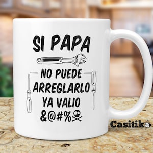 May include: White ceramic mug with a black and white design. The mug features a wrench, screwdrivers, and the text "Si Papa No Puede Arreglarlo Ya Valio &@#% ".