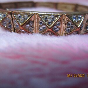 Bronze and silver link bracelet with embossed sparkle design.