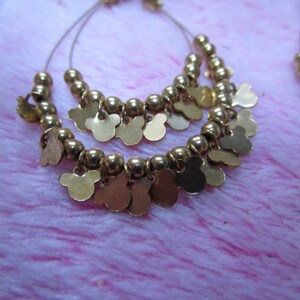 Shimmery Gold earrings with multiple mickey mouse cutouts