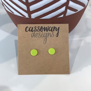 May include: A pair of neon green stud earrings on a brown card with the text "cassowary designs".