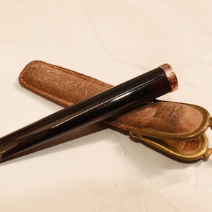 1800s cigarette holder Victoria Von Hagen Holding A