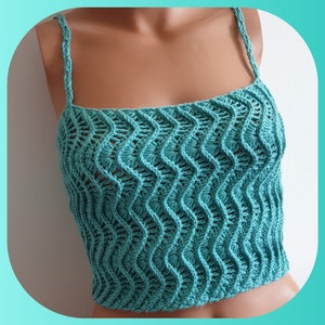 May include: A teal crochet top with a wavy pattern. The top has thin straps and a cropped length.