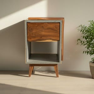 Mesita de noche clásica de hormigón gris oscuro y madera con borde vivo y cajón