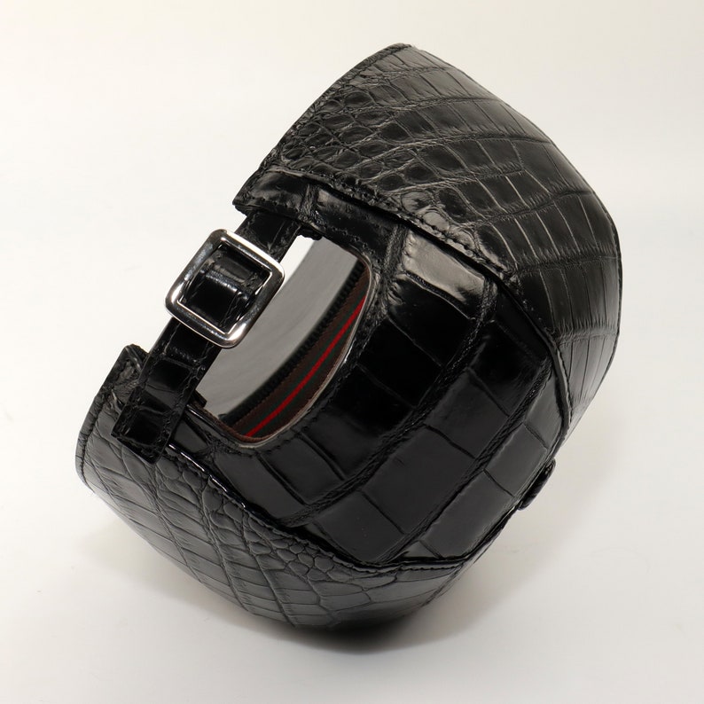 Back view of adjustable alligator cap with metal strap closure and detailed leather texture.