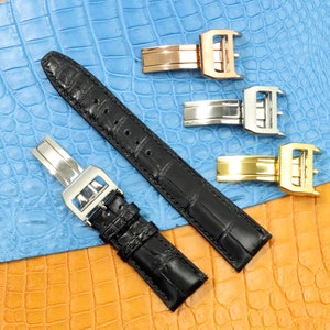 May include: Three watch straps, one black leather strap with a silver buckle, one silver metal strap with a silver buckle, and one gold metal strap with a gold buckle.