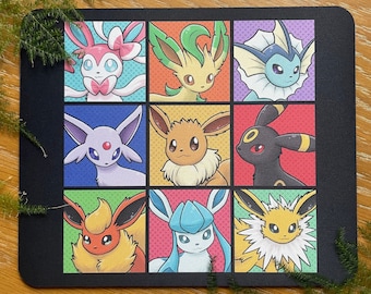 May include: A black mousepad with a grid of nine colorful squares, each featuring a different Pokemon character. The characters include: Vaporeon, Jolteon, Flareon, Espeon, Umbreon, Glaceon, Leafeon, Sylveon, and  Eevee.