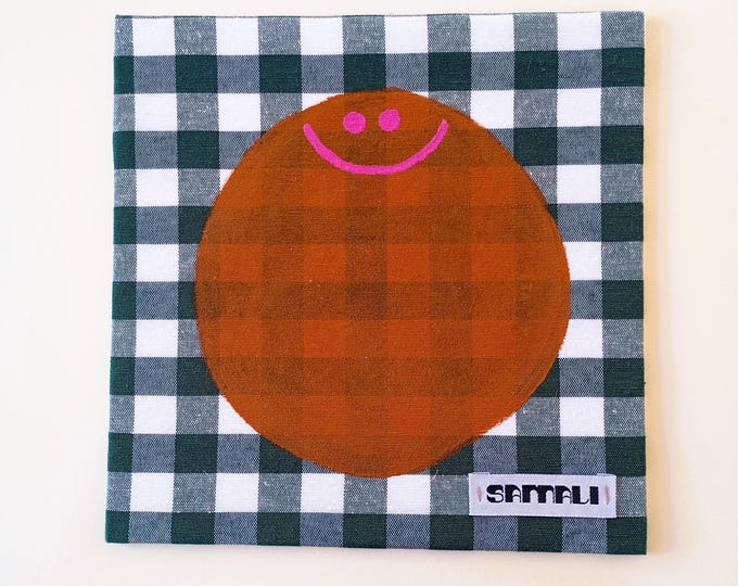 smiley- brown acrylic on green plaid