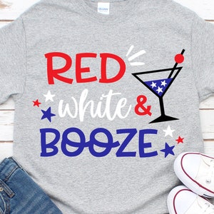 May include: Gray t-shirt with the text "RED, white & BOOZE" in red, white, and blue lettering. A martini glass with red, white, and blue stars is next to the text.