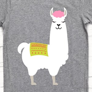 May include: A white llama with a pink head and a green and red patterned saddle. The llama is standing on a gray background.