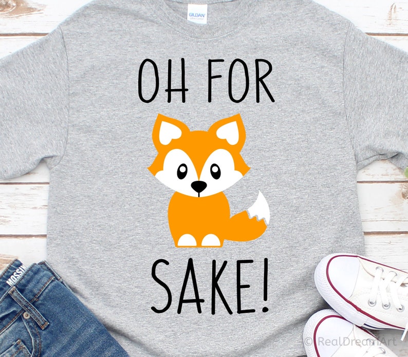 May include: A gray t-shirt with the text "Oh for sake!" printed in black. A cartoon orange fox with white eyes and a black nose is centered above the text.