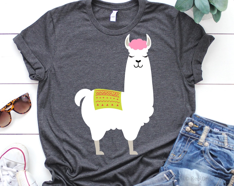May include: A dark gray t-shirt with a white llama graphic. The llama has a pink headband and a green and red patterned saddle.