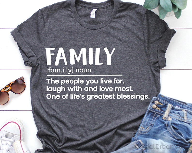 May include: Gray t-shirt with a white graphic that reads "FAMILY [fam.i.ly] noun The people you live for, laugh with and love most. One of life's greatest blessings."