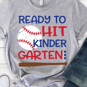 May include: Grey t-shirt with a baseball graphic and the text "Ready to Hit Kindergarten".
