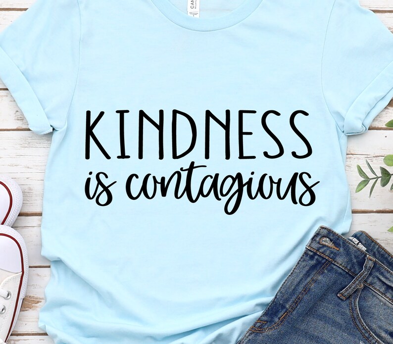 May include: Light blue t-shirt with the text "Kindness is contagious" in black lettering.