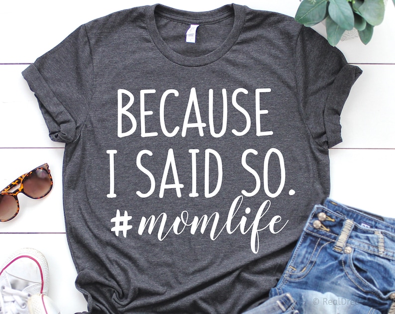May include: A dark gray t-shirt with the text "Because I said so. #momlife" printed in white.