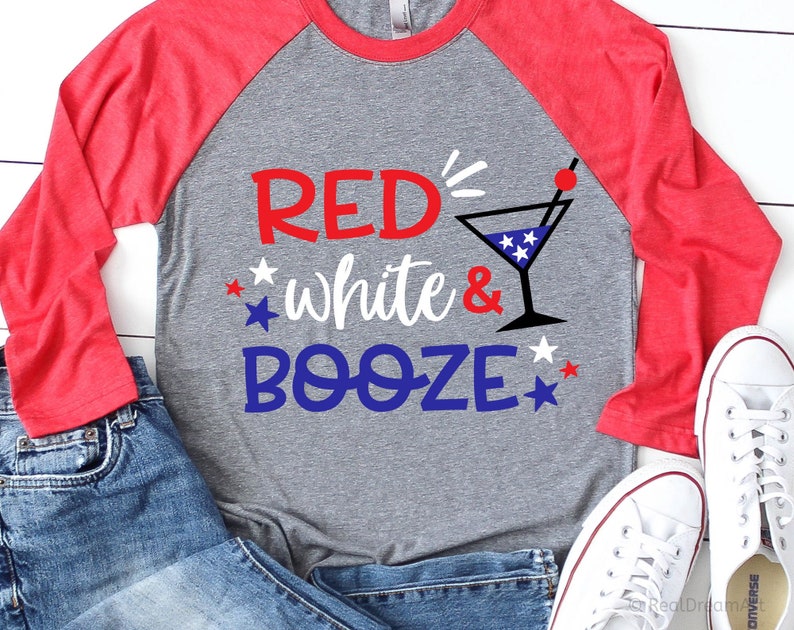May include: Red, white, and blue themed long-sleeve shirt with the text "Red's White & Booze" and a martini glass with stars on it.