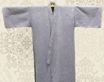 May include: A light blue and white patterned robe with a V-neck and long sleeves.