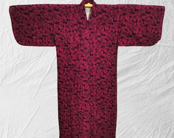 May include: A red and black floral print kimono with a V-neck and long sleeves.