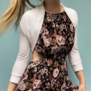 Bolero lightweight jacket, 3/4 sleeves, perfect over sleeveless dresses for arm coverage and shoulder  warmth. Colours come in black, white and navy, in sizes small, medium, large and Xlarge. Easily stored in a clutch bag, when not being worn.